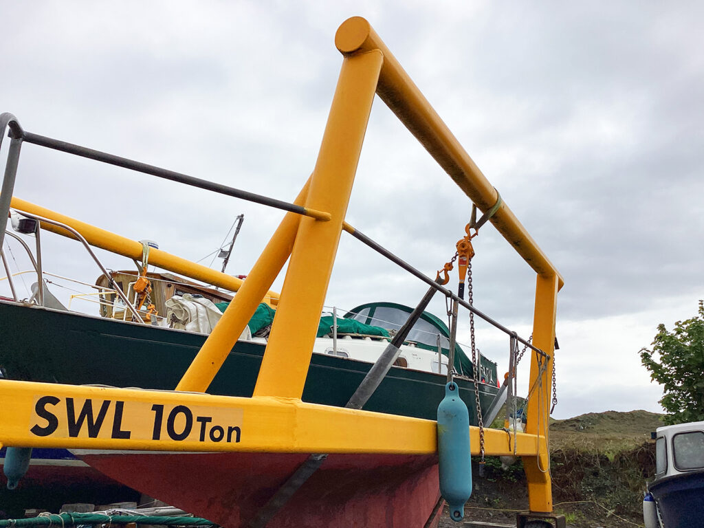 Close-up of KITO 3.2-tonne lever hoist with boatyard vessel in background