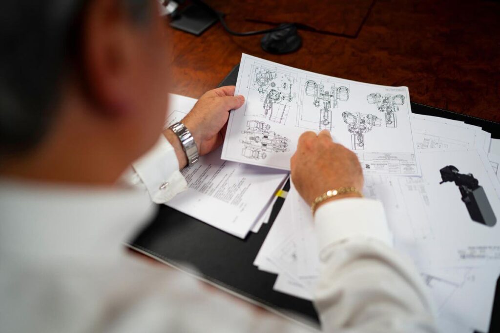 A Red Rooster Lifting Engineer analysing plans for a hire lifting solution