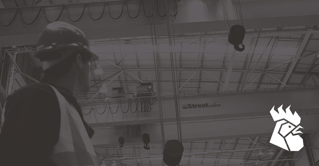 A black and white image of a crane - Red Rooster Lifting