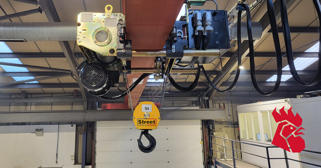 An image of a wall spanning crane hanging in a warehouse - Red Rooster Lifting